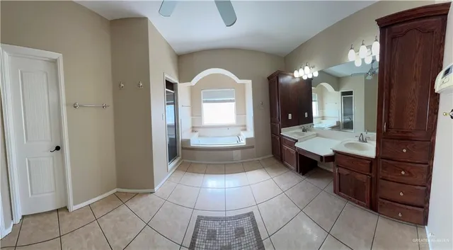 a bathroom with a double vanity sink and a mirror