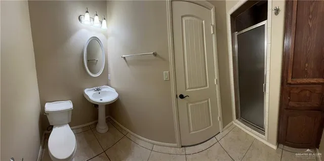 a bathroom with a light fixture and a mirror