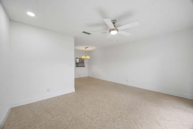 an empty room with a ceiling fan and a ceiling fan