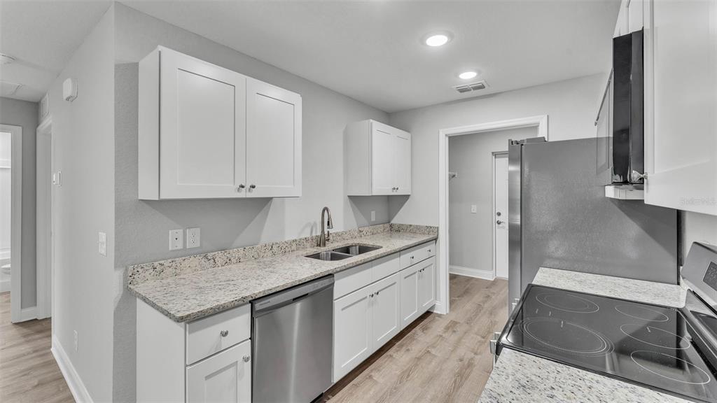 502 2nd Street Southwest Fort Meade, FL 33841 - Photo 23 of 39 a kitchen that has a sink and a stove in it