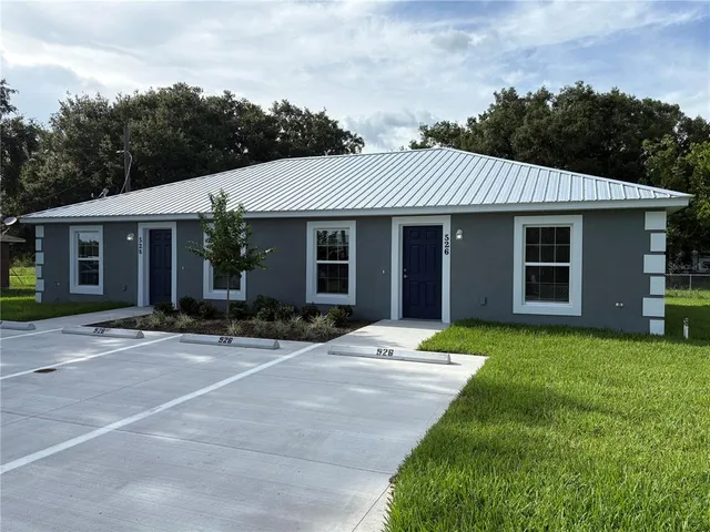 a front view of a house with a garden and porch
