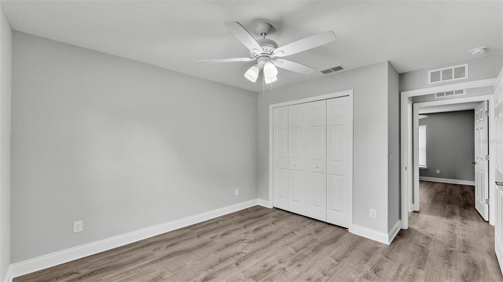 502 2nd Street Southwest Fort Meade, FL 33841 - Photo 35 of 39 an empty room with wooden floor closet and fan
