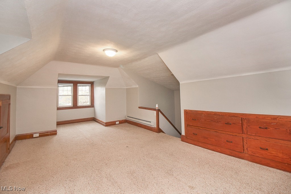 3085 Somerton Road Cleveland, OH 44118 - Photo 15 of 16 Bonus room featuring baseboards, baseboard heating, a textured ceiling, and lofted ceiling