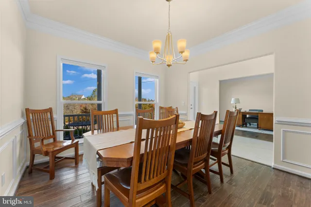 a view of a dining room with furniture wooden floor and chandelier
