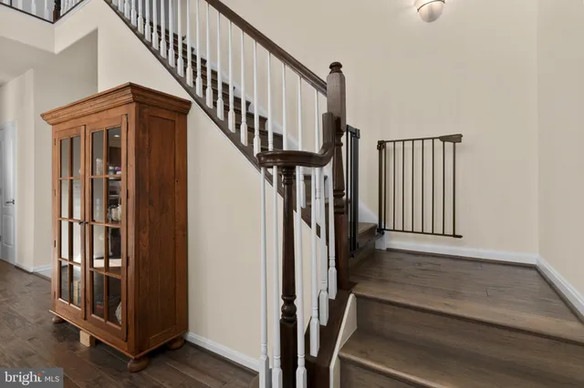 a view of a hallway with wooden floor and windows
