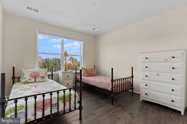 a bedroom with a bed and a dresser in it