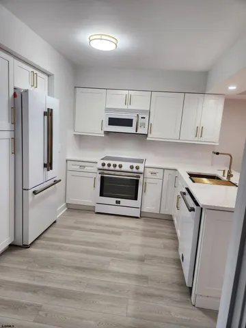 a kitchen with stainless steel appliances a stove a sink and a refrigerator