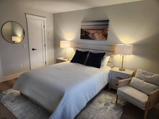 a bedroom with a bed and painting on the wall
