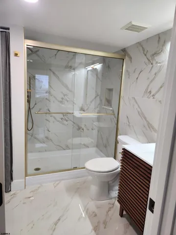 a bathroom with a shower and a toilet