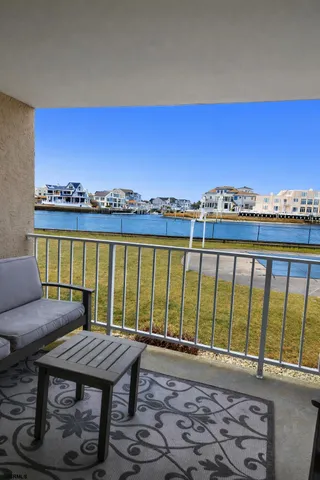 a view of a city from a balcony with furniture