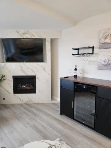 a living room with a fireplace and a flat screen tv