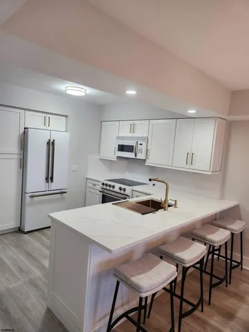 a kitchen with stainless steel appliances a stove a sink island and a refrigerator