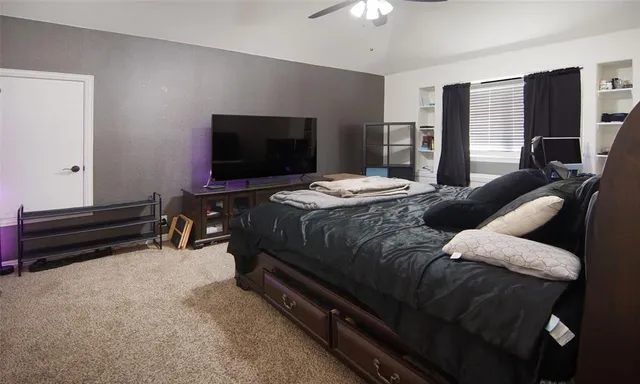 a bed room with a bed and a television