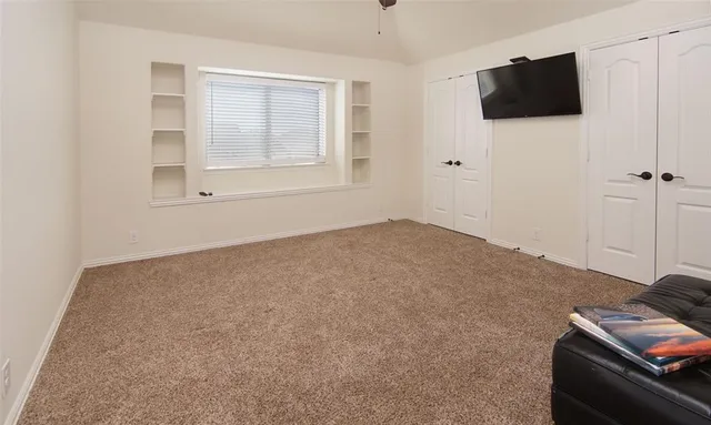 a view of empty room with a flat screen tv