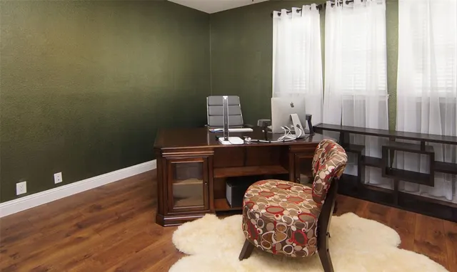 a dining room with furniture and wooden floor