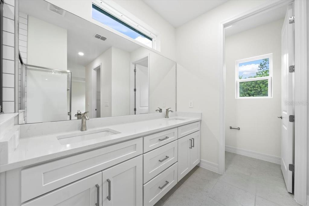 2643 Rushmore Street North Port, FL 34288 - Photo 20 of 25 a bathroom with double sink and a mirror