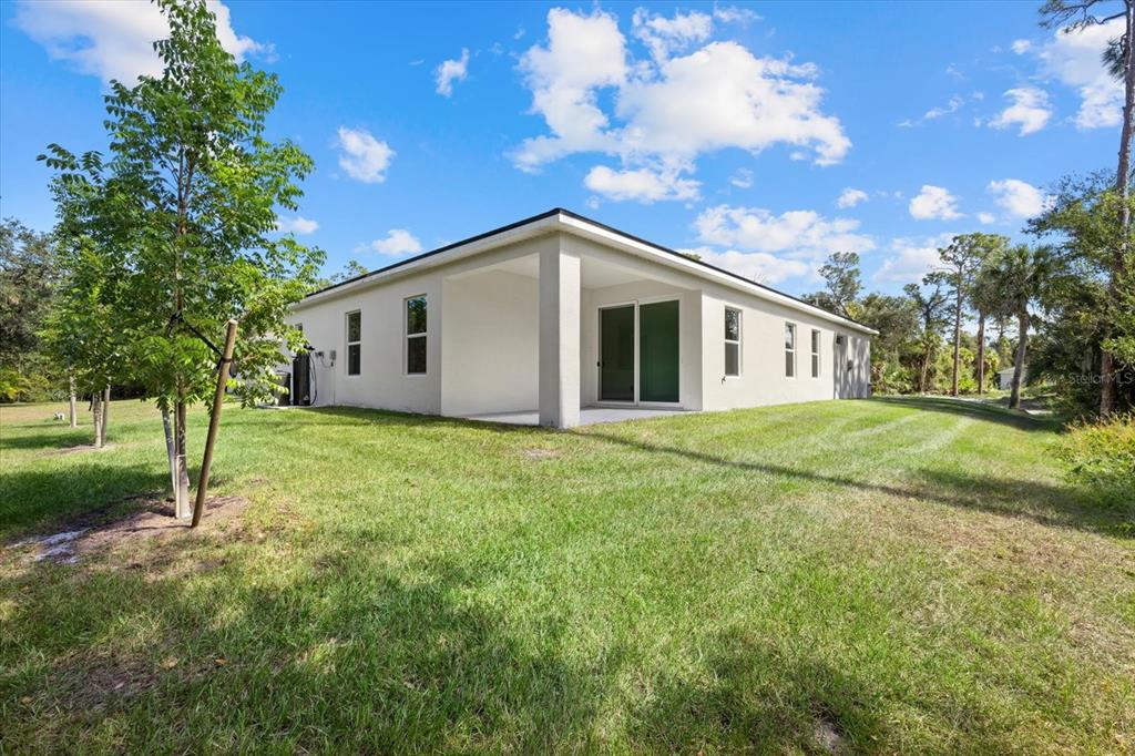 2643 Rushmore Street North Port, FL 34288 - Photo 5 of 25 a view of a house with backyard and trees