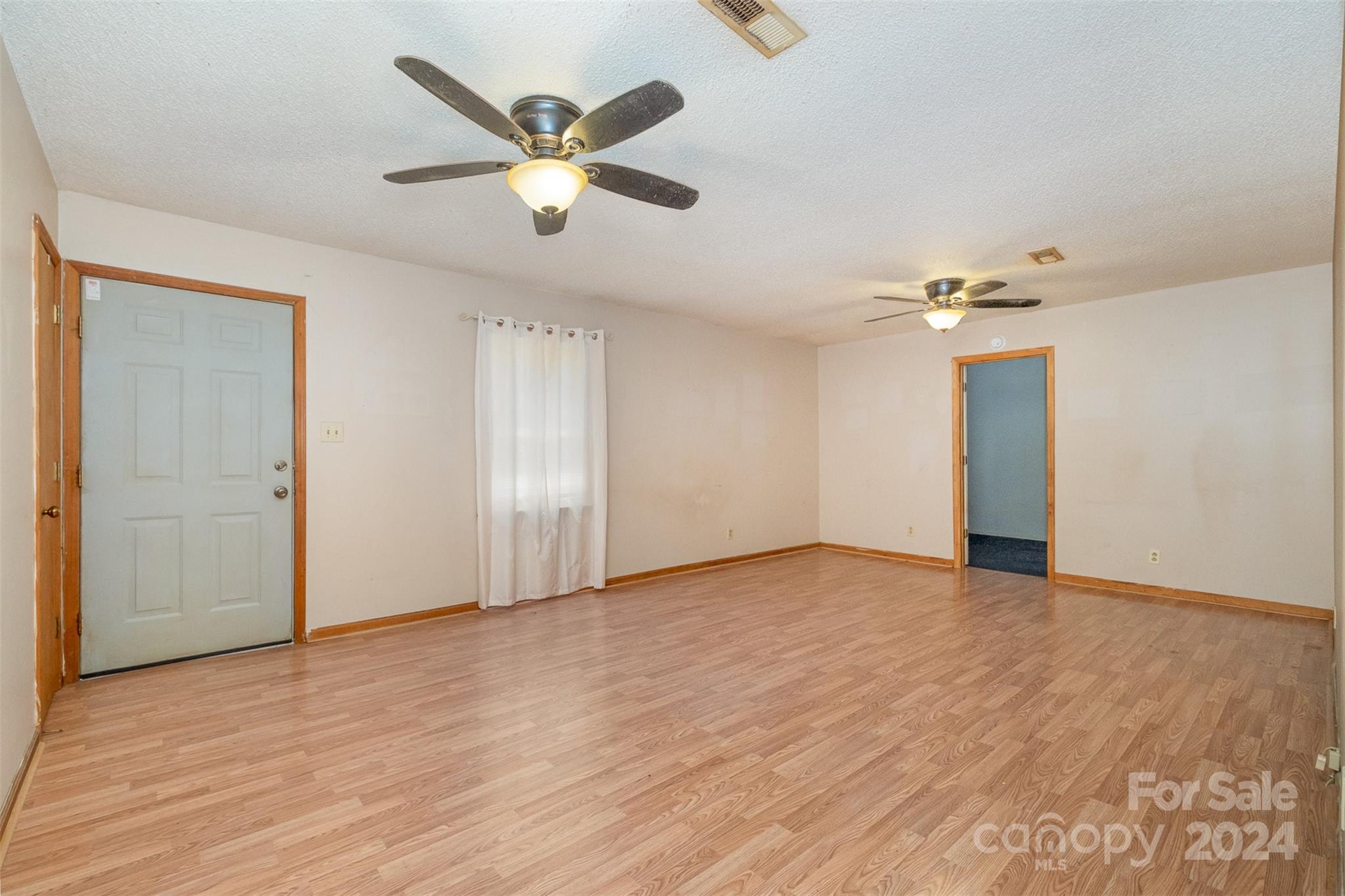 6907 St Timothy Road Marshville, NC 28103 - Photo 3 of 21 a view of an empty room with wooden floor