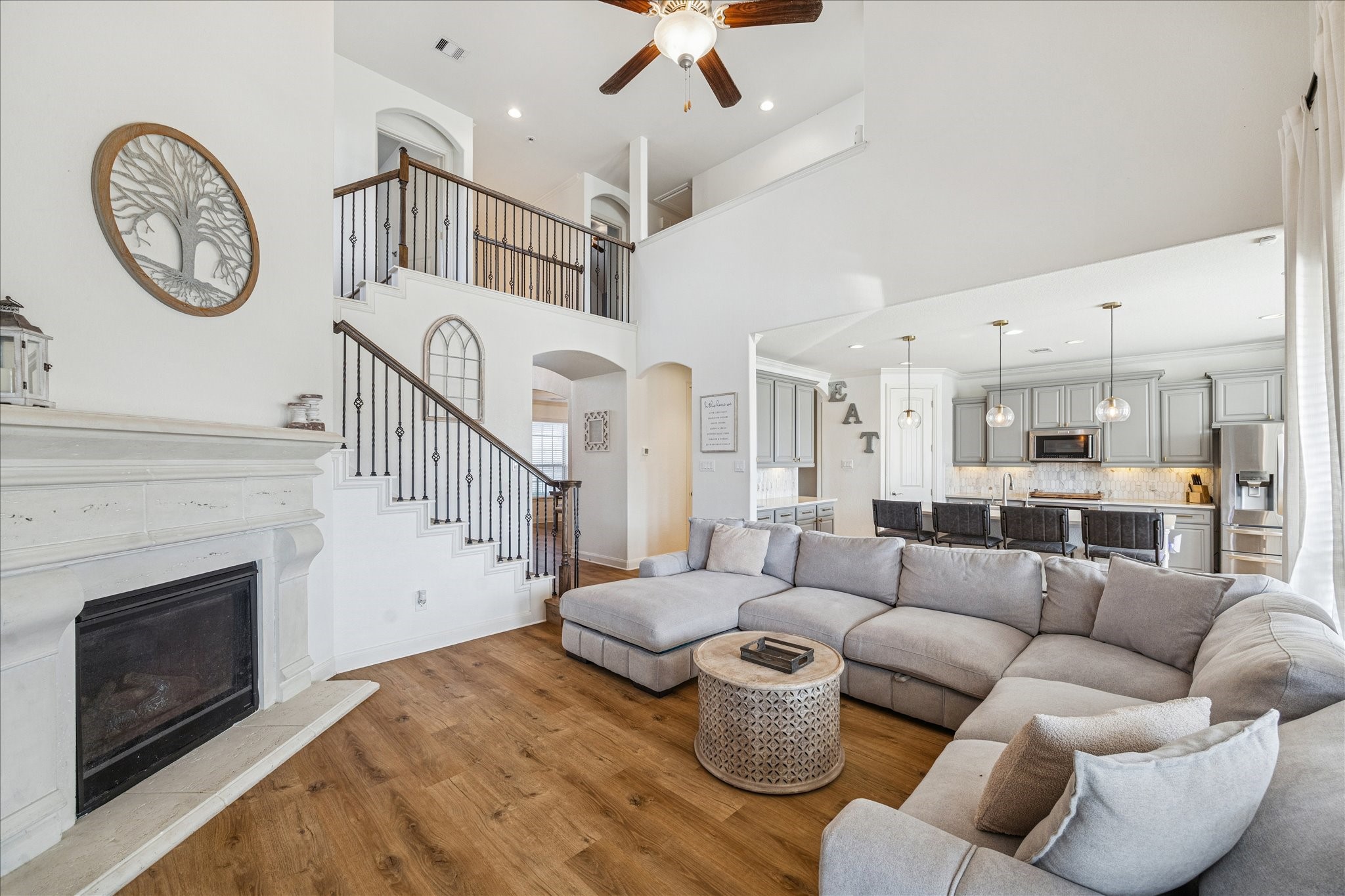 17903 Rushing Hollow Court Tomball, TX 77377 - Photo 12 of 34 a living room with furniture a fireplace and a ceiling fan