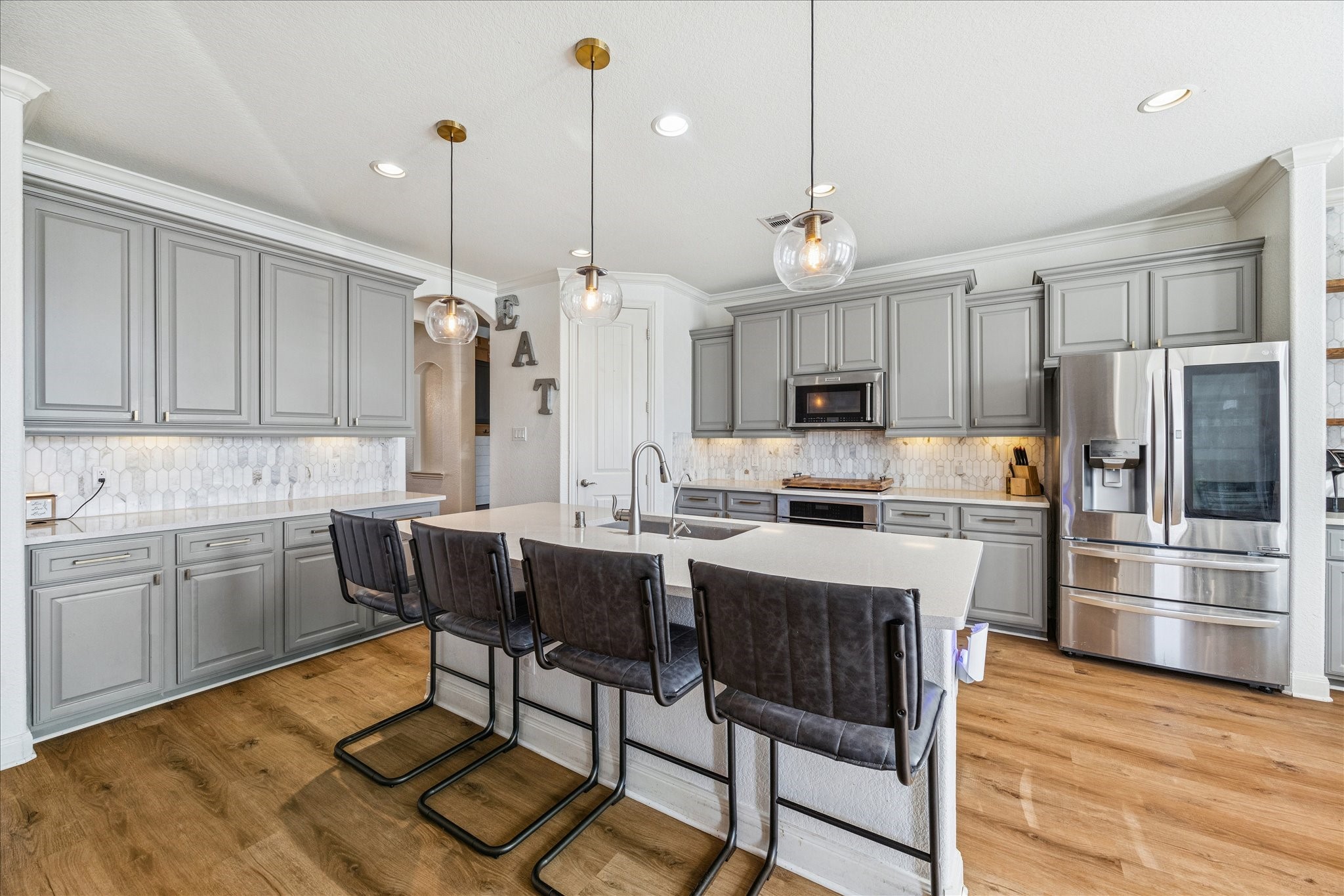 17903 Rushing Hollow Court Tomball, TX 77377 - Photo 13 of 34 a kitchen with stainless steel appliances granite countertop a table chairs sink refrigerator and microwave