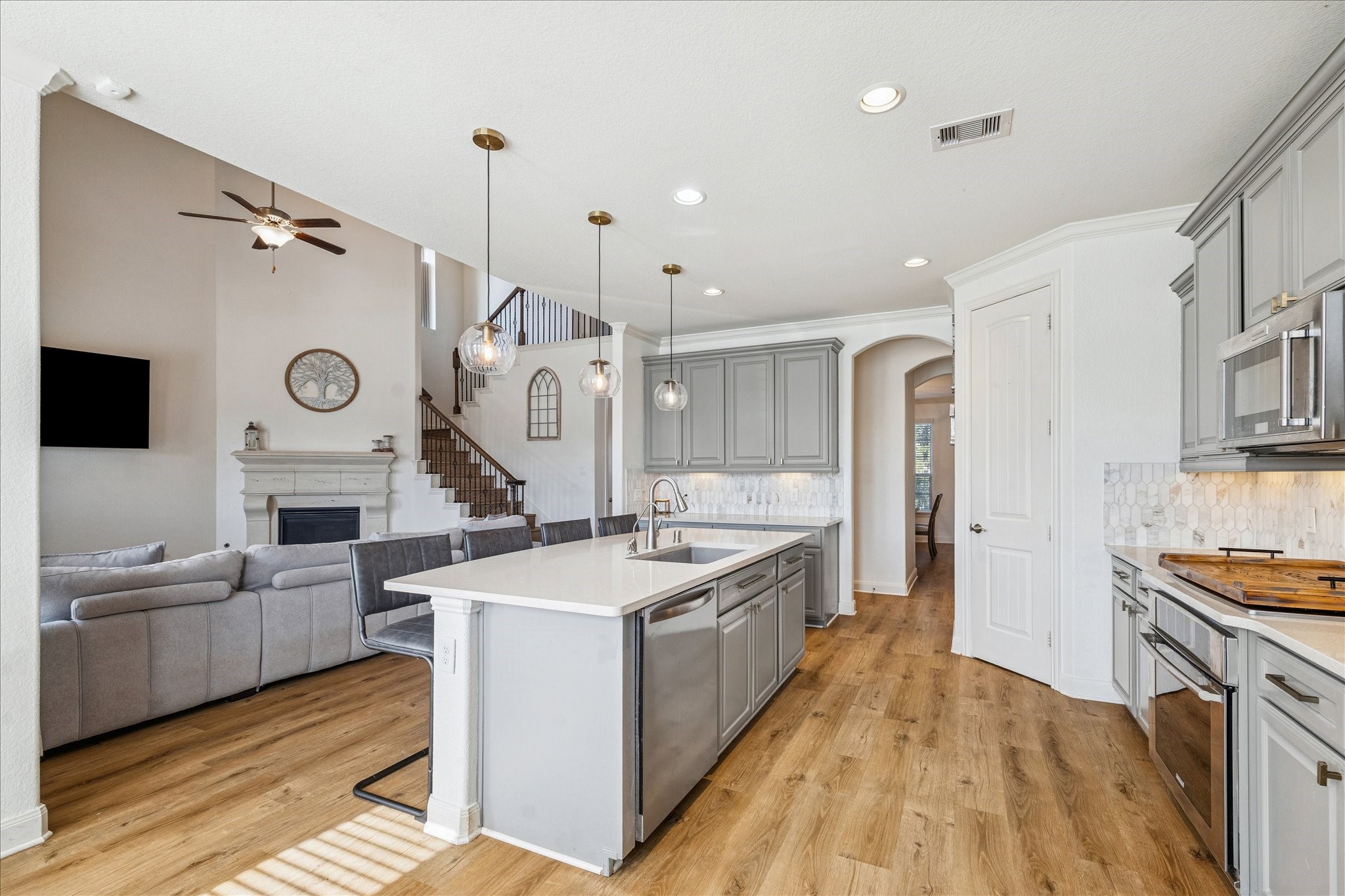 17903 Rushing Hollow Court Tomball, TX 77377 - Photo 14 of 34 a large kitchen with sink a stove and cabinets with wooden floor