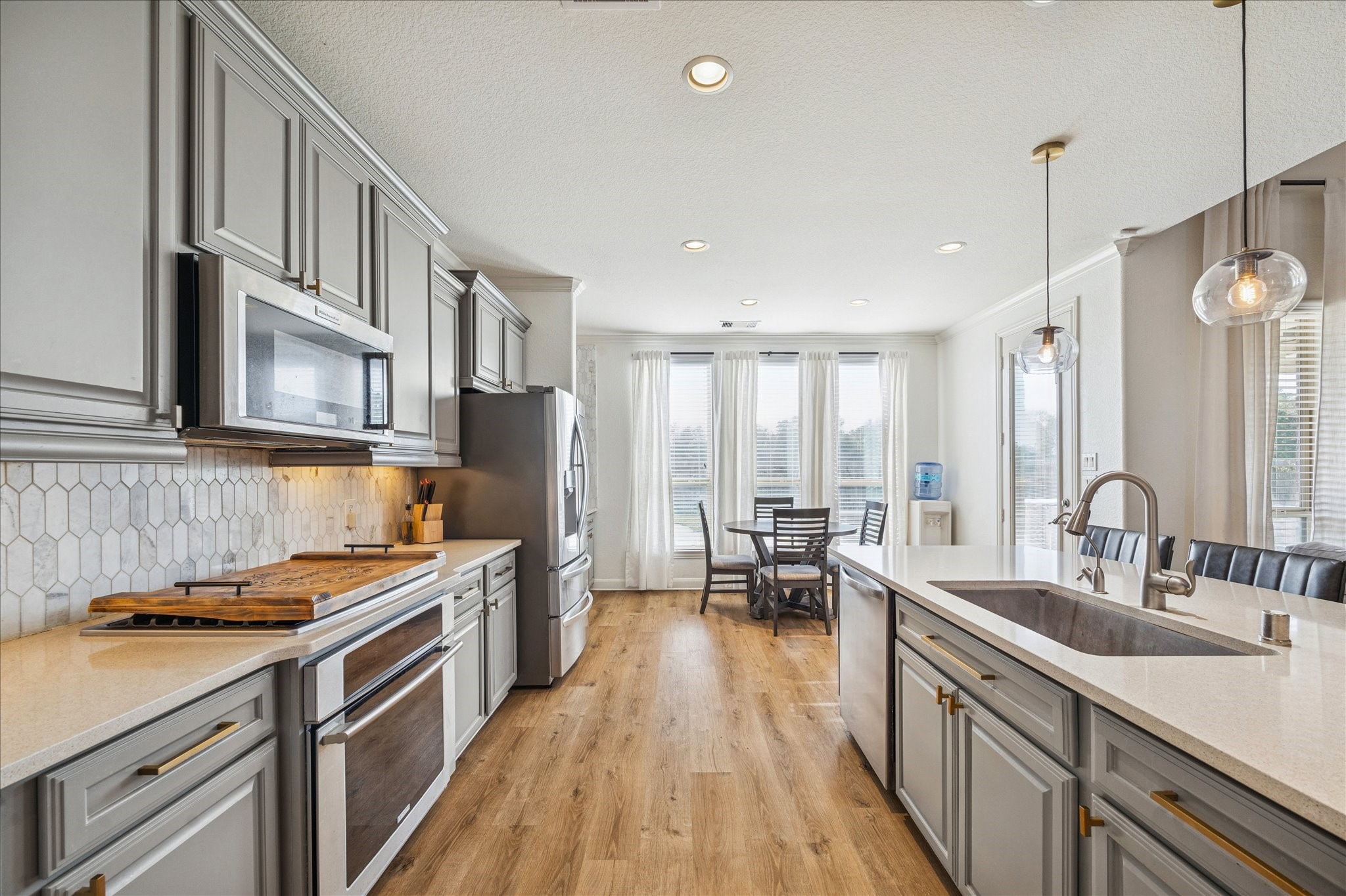 17903 Rushing Hollow Court Tomball, TX 77377 - Photo 15 of 34 a kitchen with stainless steel appliances a sink stove and cabinets