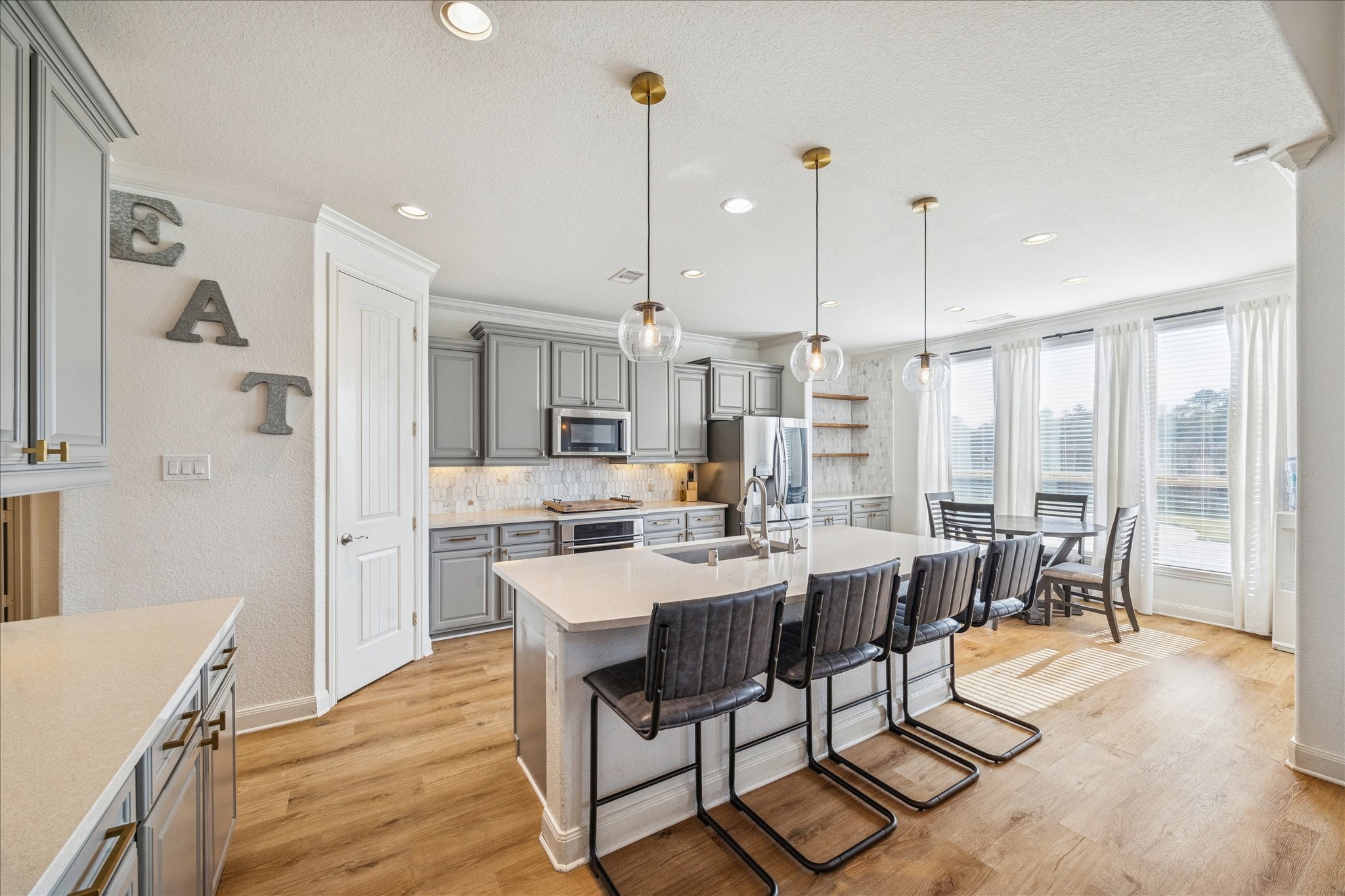 17903 Rushing Hollow Court Tomball, TX 77377 - Photo 2 of 34 a view of a dining room and livingroom with furniture wooden floor a chandelier