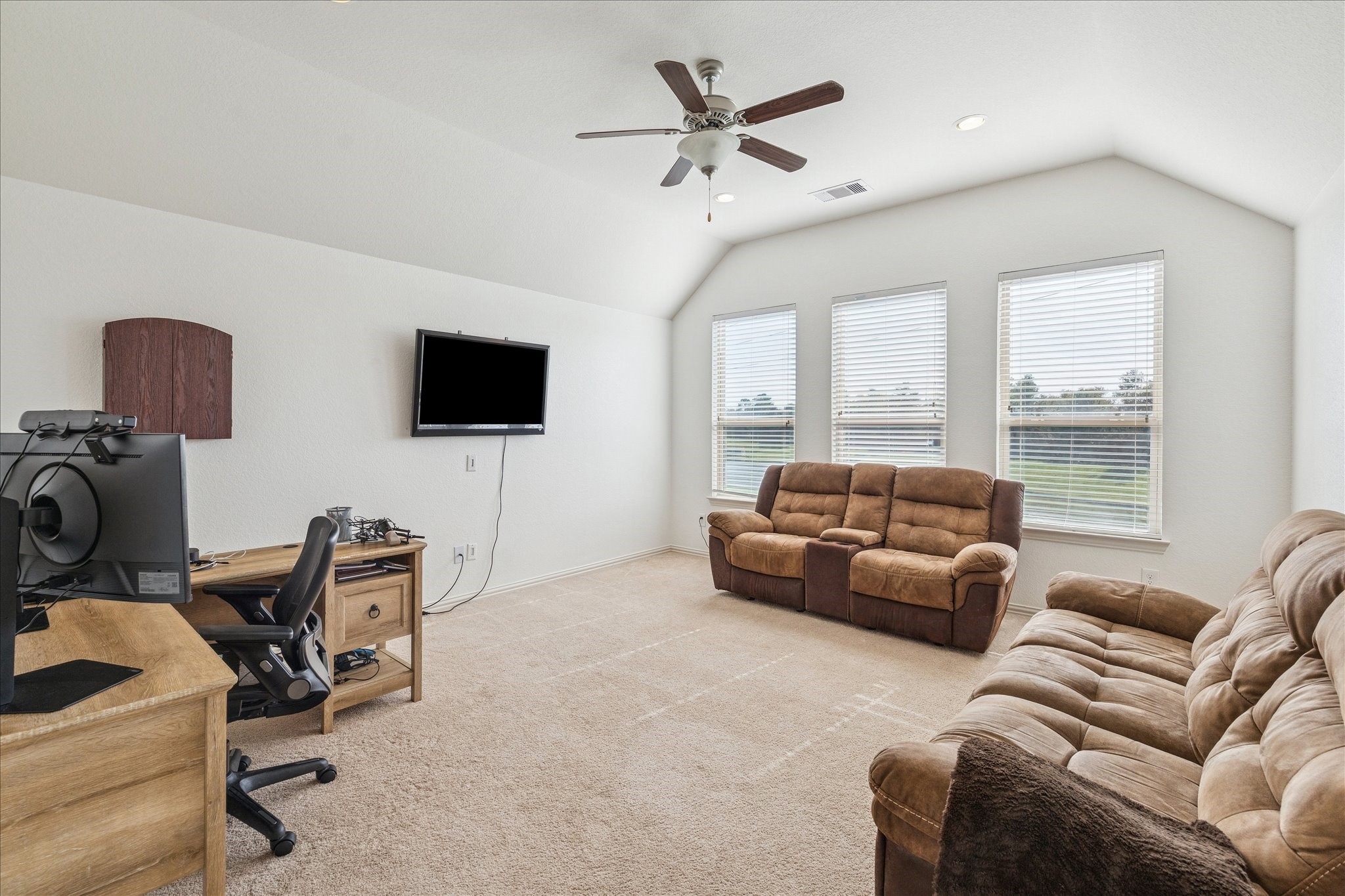 17903 Rushing Hollow Court Tomball, TX 77377 - Photo 25 of 34 a living room with furniture and a flat screen tv