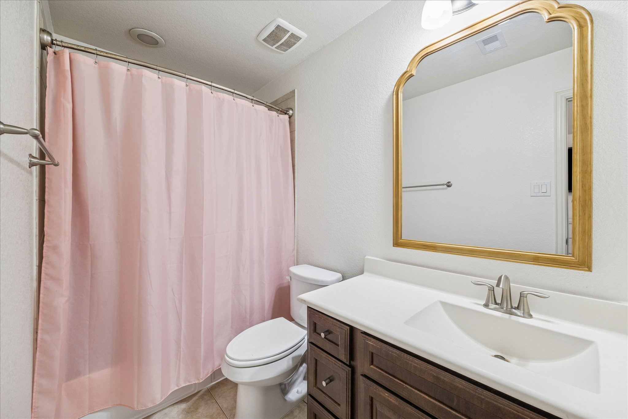 17903 Rushing Hollow Court Tomball, TX 77377 - Photo 30 of 34 a bathroom with a sink a toilet and shower curtain