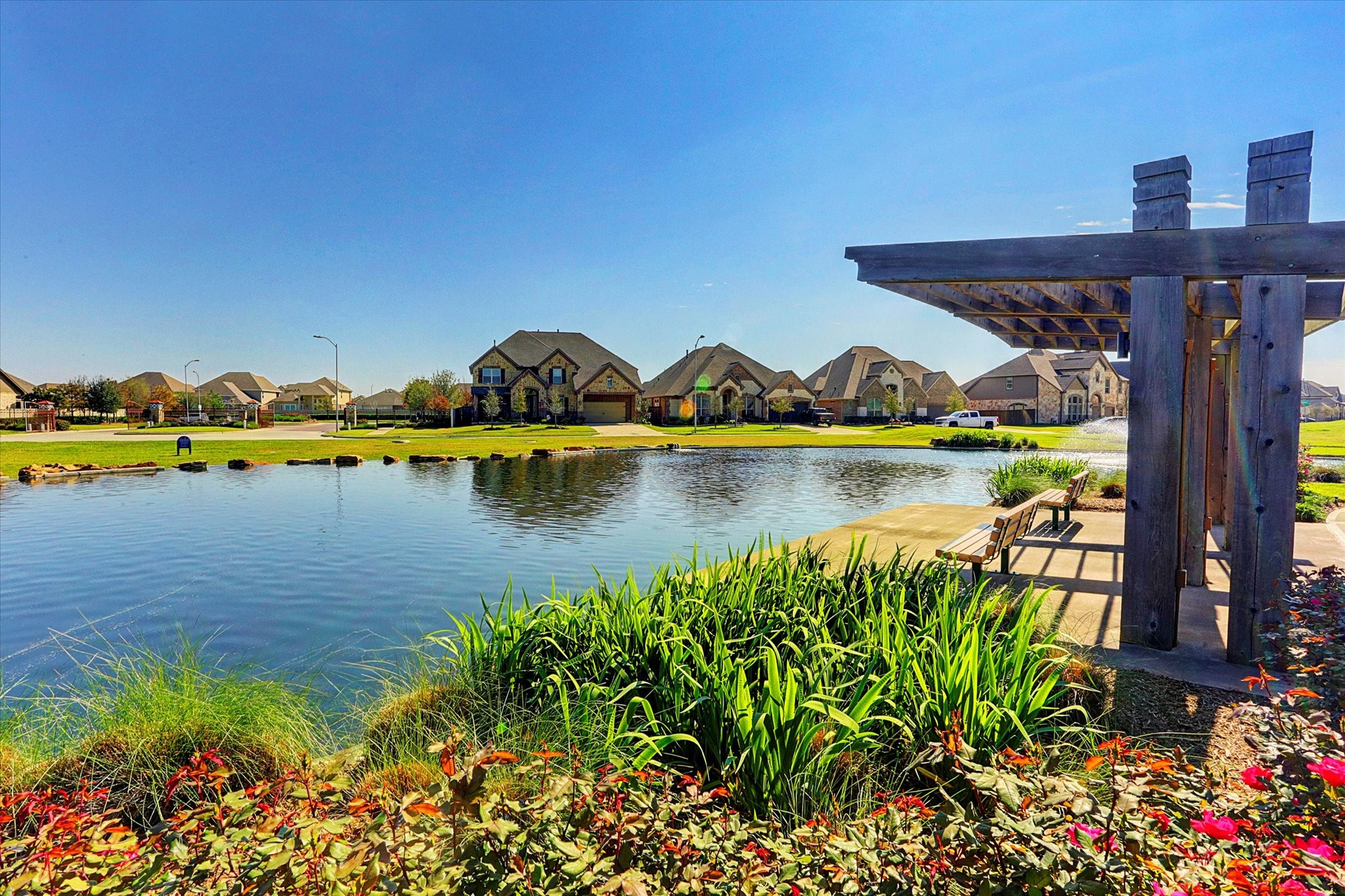 17903 Rushing Hollow Court Tomball, TX 77377 - Photo 32 of 34 a view of a lake with a house in the background