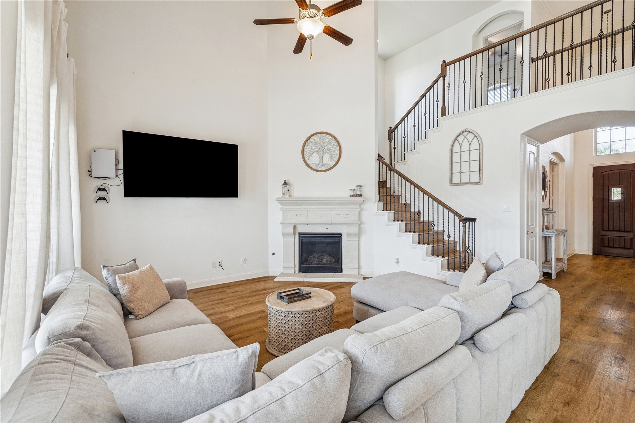 17903 Rushing Hollow Court Tomball, TX 77377 - Photo 10 of 34 a living room with furniture a flat screen tv and a fireplace