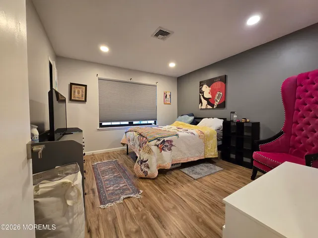 a bedroom with a bed and a painting on the wall