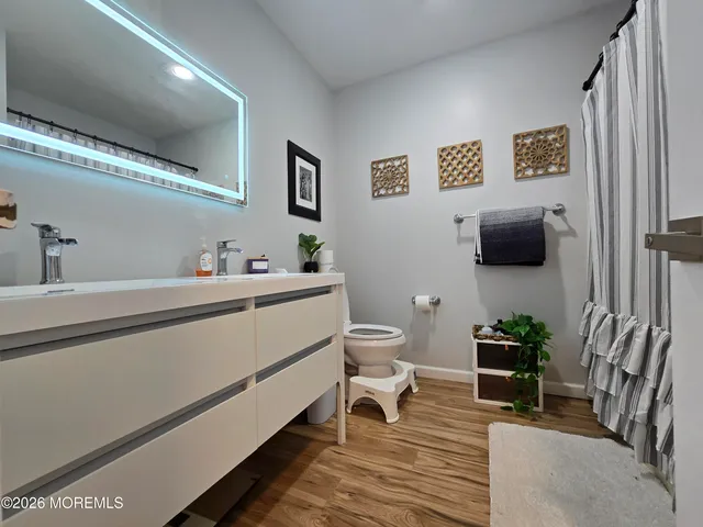 a bedroom with bed and a flat screen tv