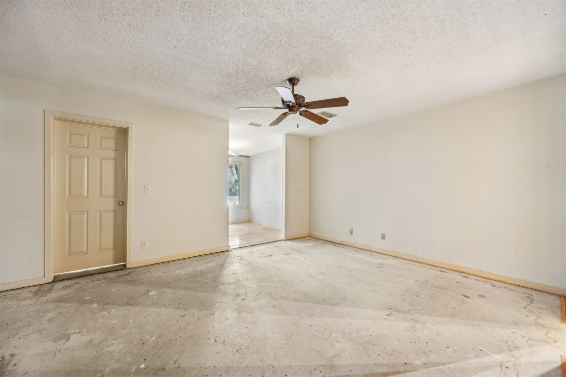 3316 Sea Marsh Road, Unit 3316 Fernandina Beach, FL 32034 - Photo 11 of 38 an empty room with a ceiling fan and a window