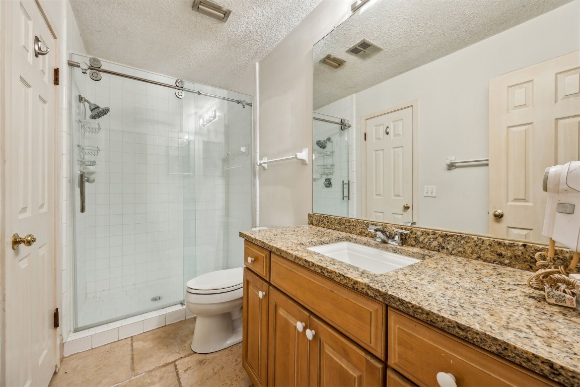 3316 Sea Marsh Road, Unit 3316 Fernandina Beach, FL 32034 - Photo 18 of 38 a bathroom with a granite countertop sink a toilet and shower