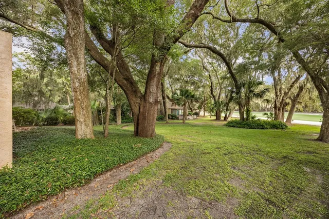 a view of a patio with table and chairs and potted plants with wooden floor and fence