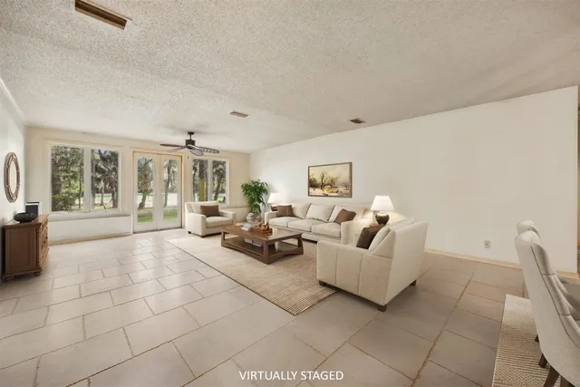 a living room with furniture and a ceiling fan