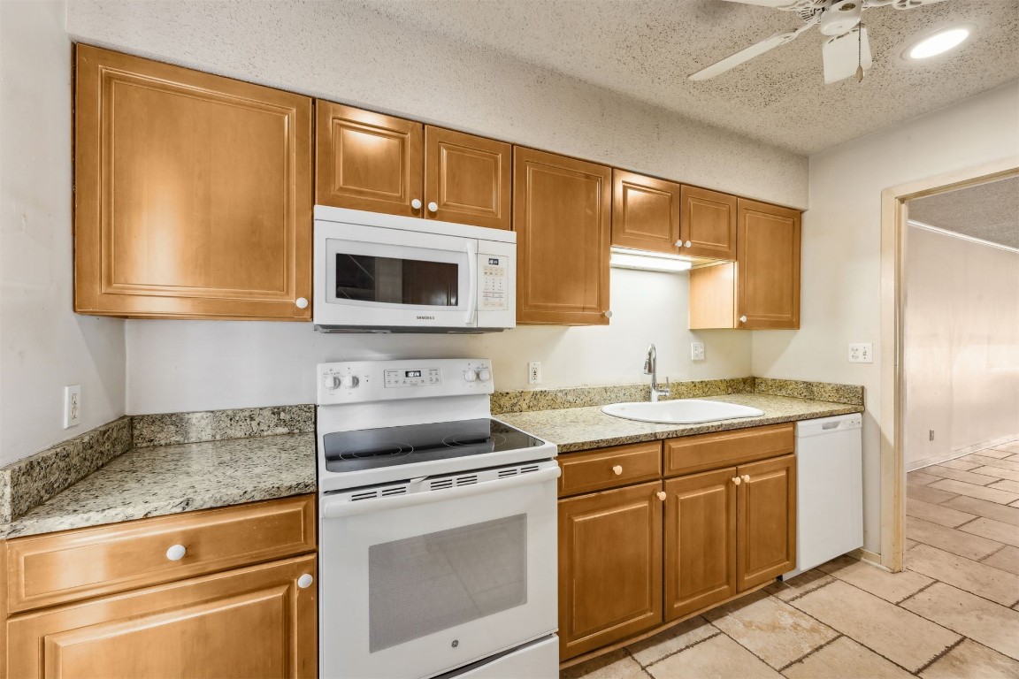 3316 Sea Marsh Road, Unit 3316 Fernandina Beach, FL 32034 - Photo 10 of 38 a kitchen with stainless steel appliances granite countertop a stove microwave and cabinets