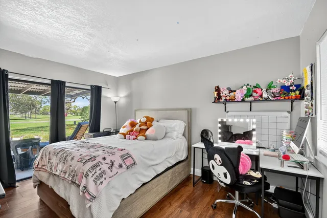 a front view of a house with a yard and potted plants