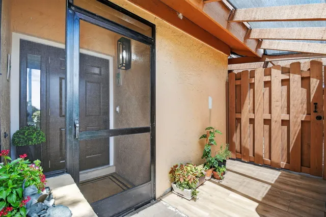 a kitchen with stainless steel appliances granite countertop a dining table chairs sink refrigerator and cabinets