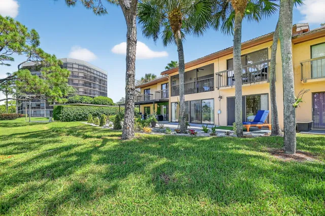 a room with lots of tables a large window and chairs