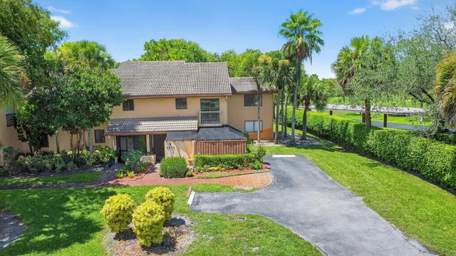 an aerial view of a city with lots of residential buildings and mountain view in back