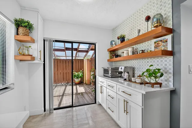a kitchen with stainless steel appliances kitchen island granite countertop a refrigerator and a sink