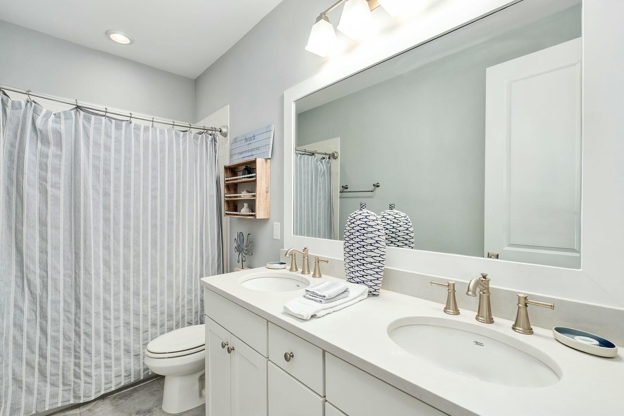 116 Prairie Pass Santa Rosa Beach, FL 32459 - Photo 28 of 59 a bathroom with a double vanity sink toilet and a mirror