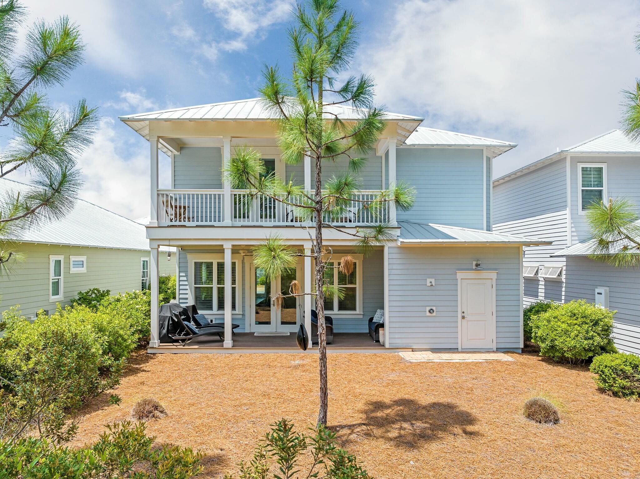 116 Prairie Pass Santa Rosa Beach, FL 32459 - Photo 32 of 59 a view of a house with a yard and potted plants
