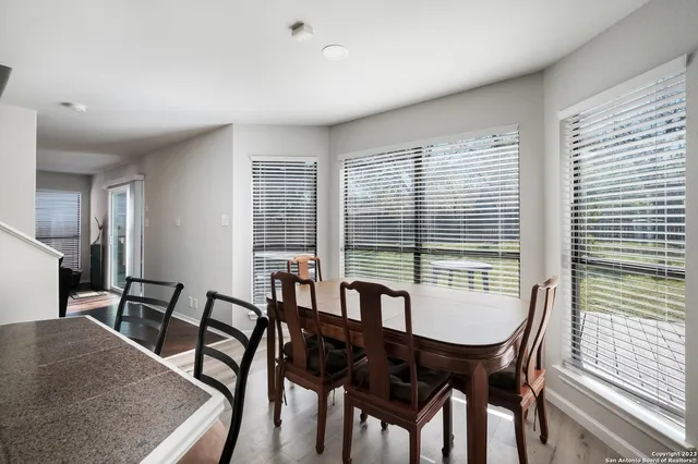a view of a dining room with furniture and window