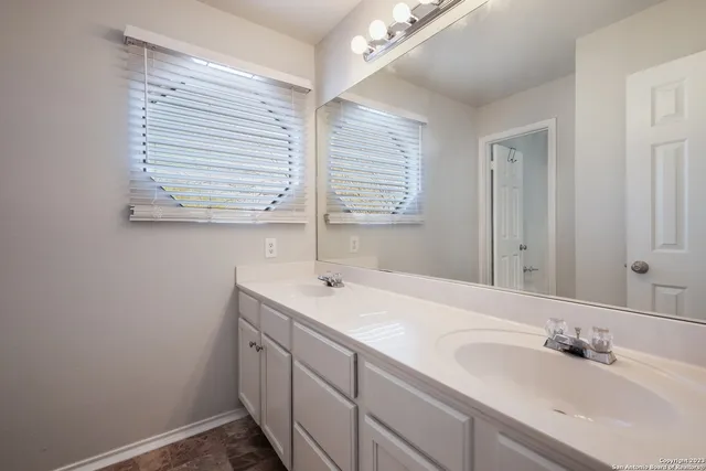 a bathroom with a sink and a window