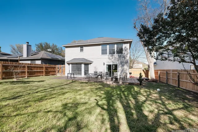 a view of a house with swimming pool and sitting area