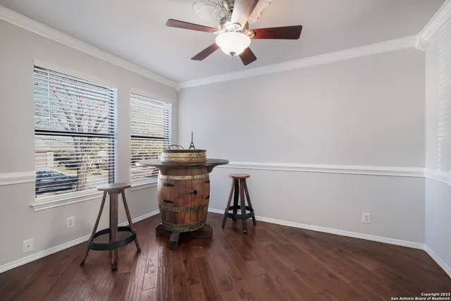 a view of a workspace with furniture and a window