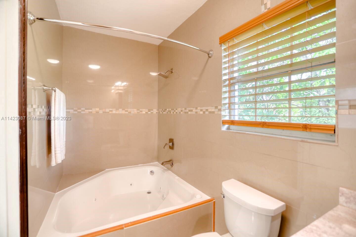 3628 Thomas Avenue Miami, FL 33133 - Photo 12 of 24 a bathroom with a bathtub a toilet and a shower
